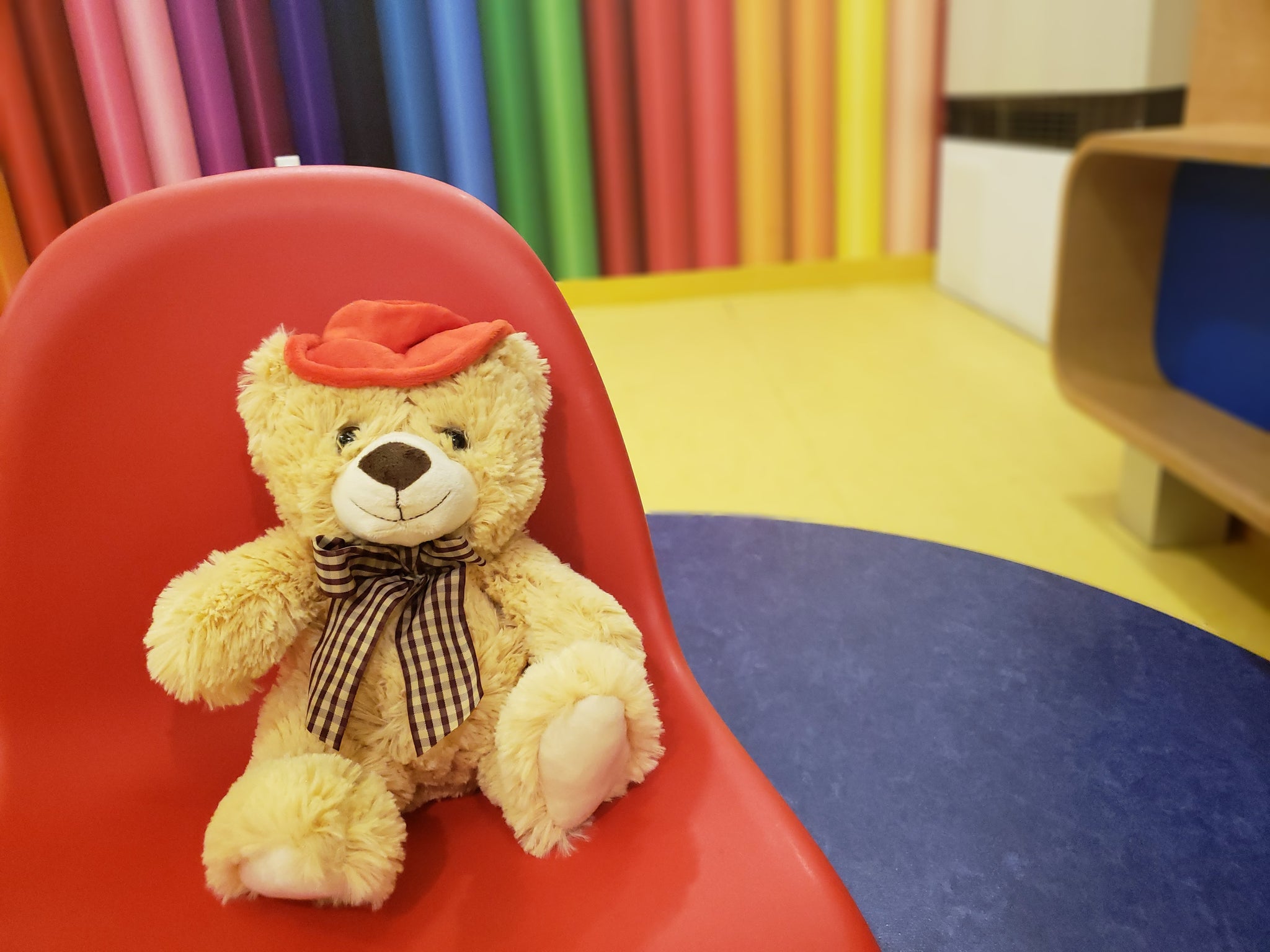 TeddyMozart Bluetooth teddy bear alongside the companion mobile app on a smartphone
